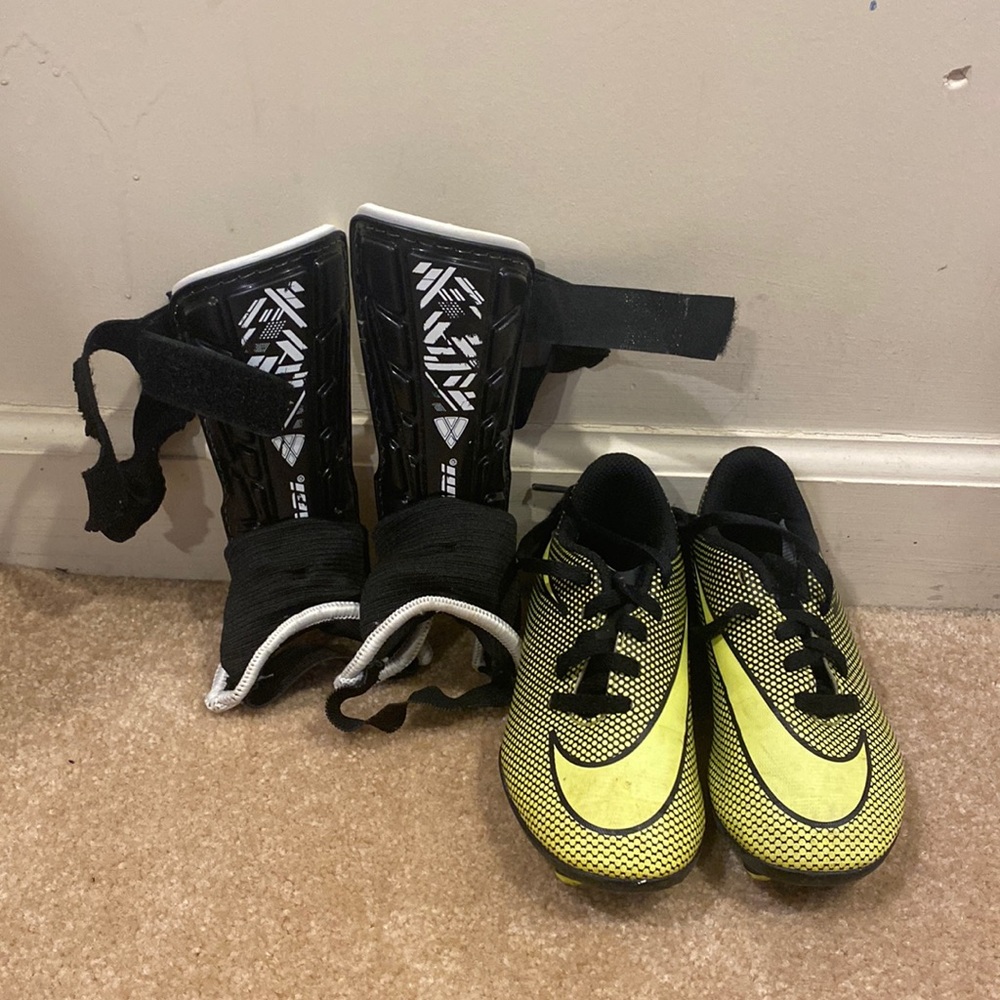 Unisex cleats with shin guards, size 10C, used but still in good condition